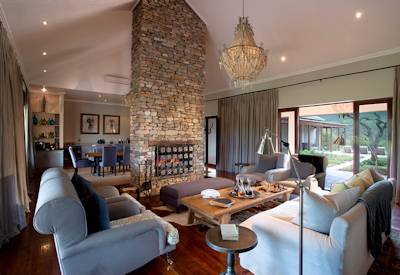 Spacious lounge with lofty ceilings and deep couches at Kwandwe Melton Manor Eastern Cape