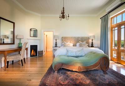 Antique-furnished suite with yellowwood chest and claw-foot tub at Kwandwe Uplands House