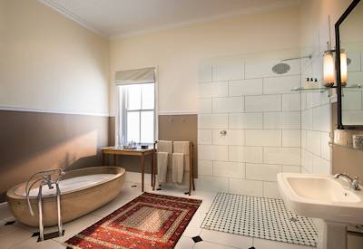 Antique claw-foot bathtub and antique mirror en-suite at Kwandwe Uplands House Kwandwe Reserve