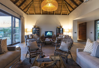 Thatched central lounge with fireplace at Shamwari Sarili exclusive-use lodge Shamwari Reserve