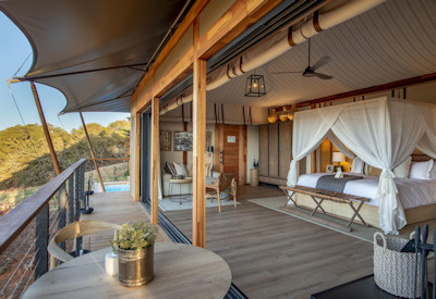 Luxury tented suite with four-poster bed and fireplace at Shamwari Sindile Shamwari Reserve