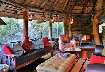 Central guest lounge with fireplace at Sibuya Forest Camp Kariega River Estuary Eastern Cape