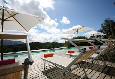 A swimming pool with sun loungers