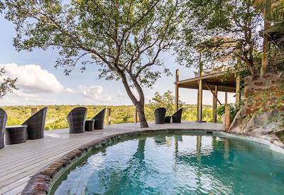 Beautiful swimming pool with sun loungers and deck