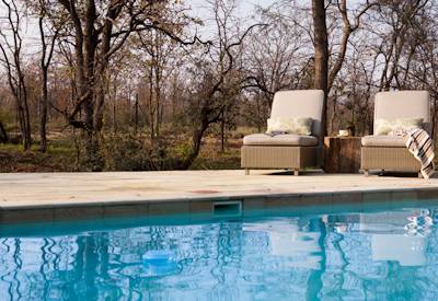 Swimming pool with sun loungers