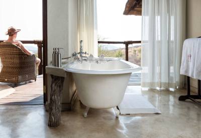 Freestanding bathtub in luxury en-suite bathroom at Impodimo Game Lodge Madikwe