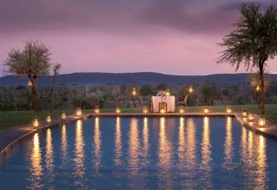 A serene swimming pool surrounded by nature