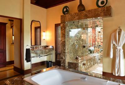 Marble en-suite bathroom with freestanding bathtub at Mateya Safari Lodge Madikwe