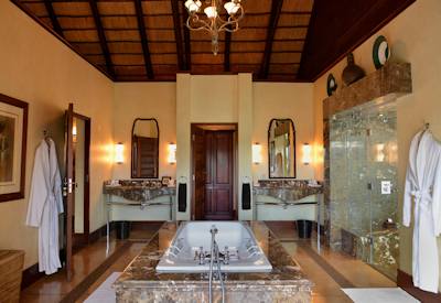 Luxury bathtub with indoor and outdoor showers at Mateya Safari Lodge Madikwe