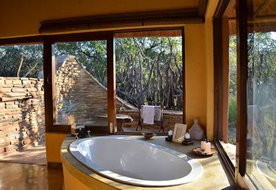 En-suite bathtub overlooking Madikwe bushveld at Motswiri Safari Lodge