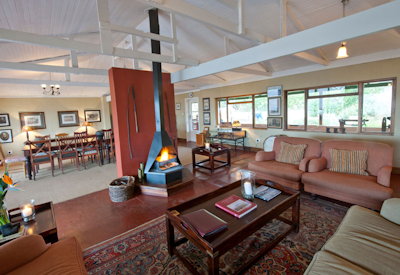 Central guest lounge with library and fireplace at Fugitives Drift Guest House Natal