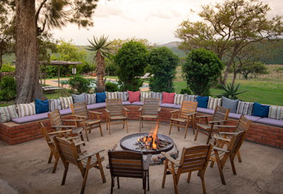 Outdoor boma firepit and dining area under stars at Fugitives Drift Guest House Natal