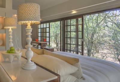 Luxury king-size bedroom suite with forest views at AndBeyond Phinda Forest Lodge Zululand