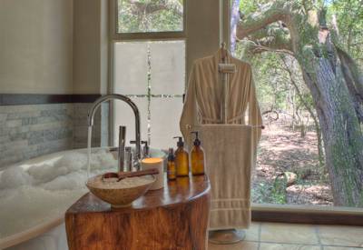 Luxury king-size bedroom suite with forest views at AndBeyond Phinda Forest Lodge Zululand