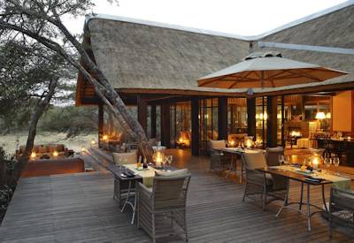 Thatched central guest lounge and fireplace at AndBeyond Phinda Vlei Lodge Phinda Reserve