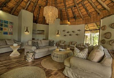 Thatched rondavel lounge and dining area at Thonga Beach Lodge iSimangaliso KwaZulu-Natal