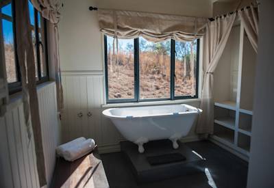 Freestanding bathtub in en-suite bathroom at Three Tree Hill Lodge KwaZulu-Natal