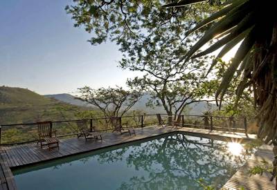 Sheltered swimming pool with Drakensberg Mountain views at Three Tree Hill Lodge Natal
