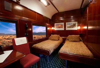 Rovos Rail twin-bed luxury suite teak panelling desert views Southern Cross Safari