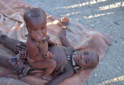 Himba people Kaokoland Namibia Ken Vine cooking fire outside rondavel daily activities communal life