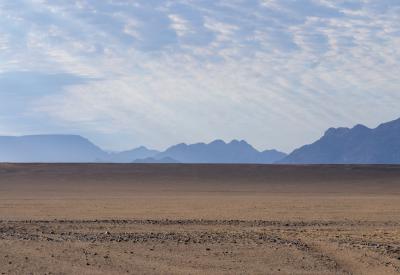 Road to Sossusvlei Namibia tarred road Namib Desert dunes morning golden light photography