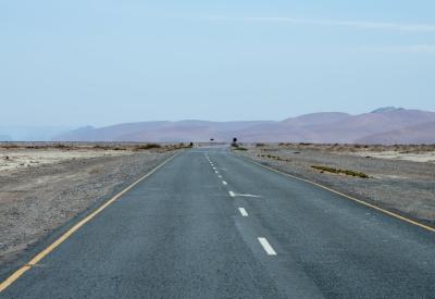 Sossusvlei road Namibia tarred straight road dunes both sides Namib Naukluft photography