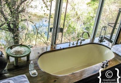 Singita Sweni Lodge suite river views bedroom lounge daybed veranda mosquito net Kruger National Park