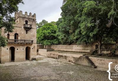 Fasilides Bath Gondar Ethiopia stone towers dramatic highland sky backdrop photography Uyaphi