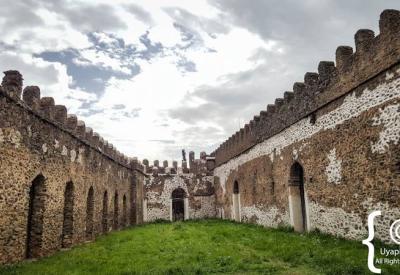 Fasil Ghebbi Gondar Ethiopia castle tower ruins dramatic golden light photography