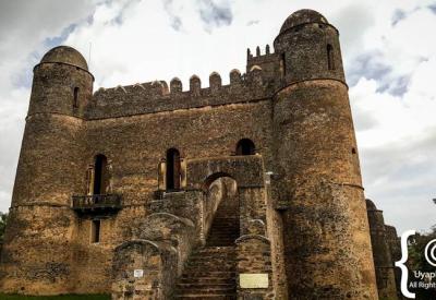 Fasil Ghebbi Gondar Ethiopia castle tower ruins dramatic golden light photography