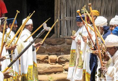 Ethiopian Orthodox priest white ceremonial robes cross Lalibela people photography