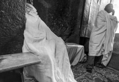 Ethiopian Orthodox priest white ceremonial robes cross Lalibela people photography
