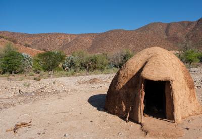 Ovahimba Himba woman preparing otjize ochre paste Kaokoland Namibia cultural safari