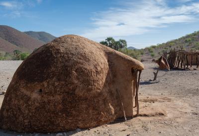 Ovahimba Himba woman preparing otjize ochre paste Kaokoland Namibia cultural safari