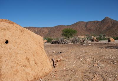 Ovahimba Himba mother carrying child Kaokoland Kunene River Namibia cultural safari