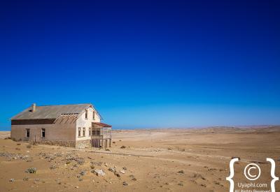 Kolmanskop window frame Namib Desert view ghost town photography Luderitz Namibia