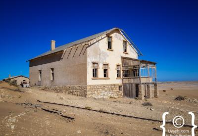 Kolmanskop window frame Namib Desert view ghost town photography Luderitz Namibia