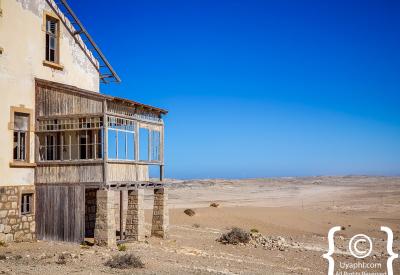 Kolmanskop window frame Namib Desert view ghost town photography Luderitz Namibia