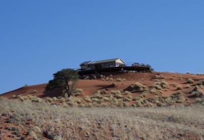 Namib Dune Star Camp wheeled bed rolled onto verandah sleeping under African stars Namibia