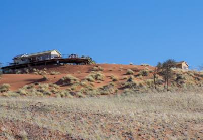 Namib Dune Star Camp wheeled bed rolled onto verandah sleeping under African stars Namibia