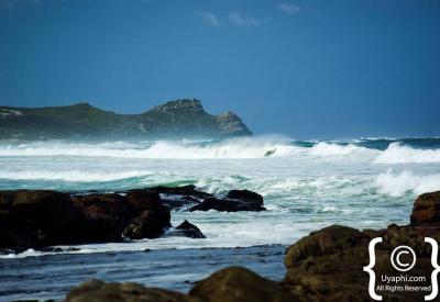 Dramatic 200m sheer cliff faces meeting Atlantic Ocean Cape Point Nature Reserve Cape Town