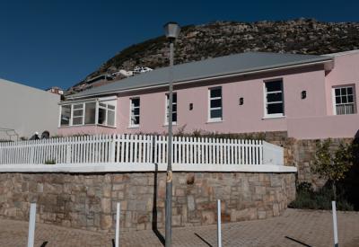 Tintswalo Summer House eclectic decor lounge with fresh flowers Glencairn Cape Town