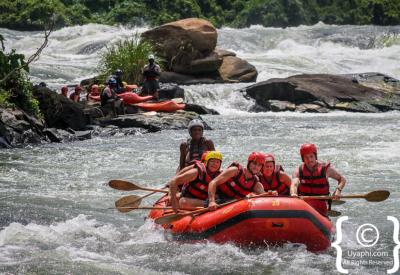 White water rafting team high five Nile River Uganda Jinja
