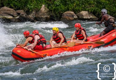Rafting team navigating grade 4 rapid Nile River Jinja Uganda