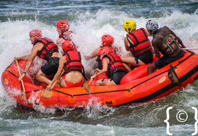 Raft guide steering grade 4 rapid Nile River Uganda Jinja