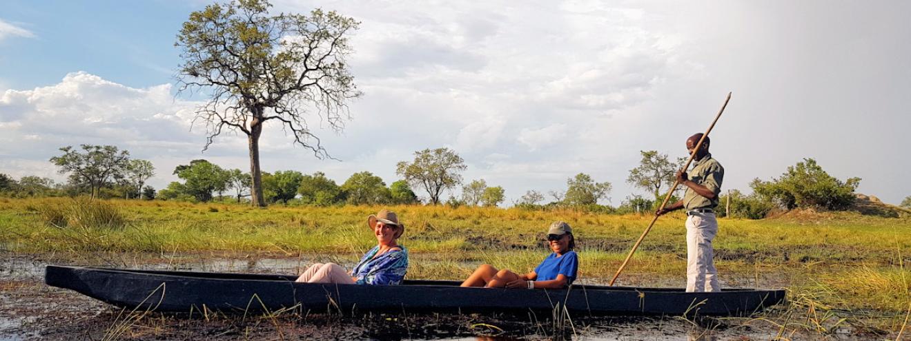 Mokoro Okavango Delta Botswana traditional dugout canoe poler ngashi waterways channels UNESCO World Heritage