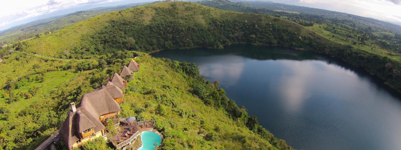 Kyaninga Lodge 9 cottages hand-carved log architecture Lake Kyaninga Kibale Uganda