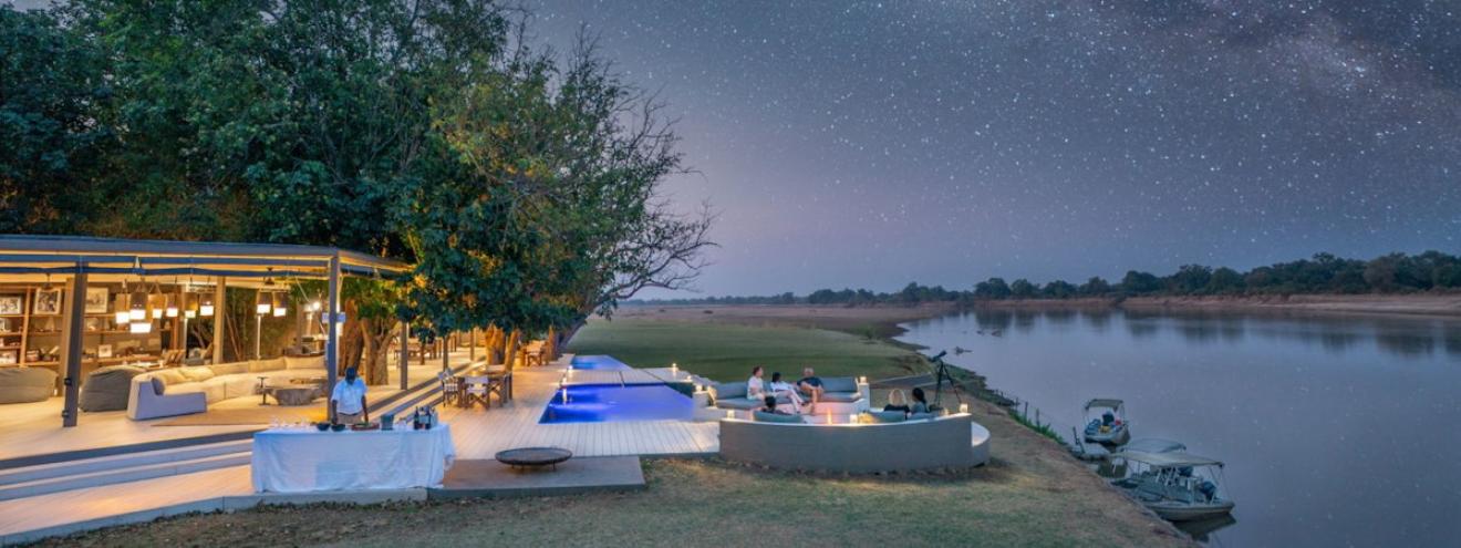 Chinzombo Safari Camp ultra-luxury canvas and timber villas nestled under ancient shade trees along the Luangwa River