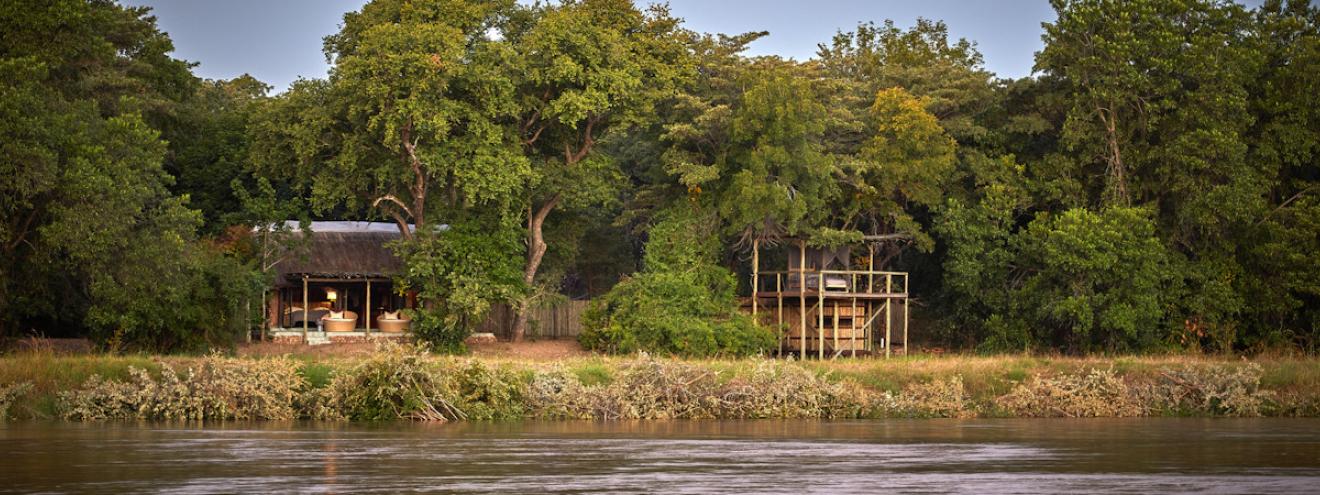 Kapamba Bushcamp luxury thatched stone chalet with open-fronted views overlooking the scenic riverbed