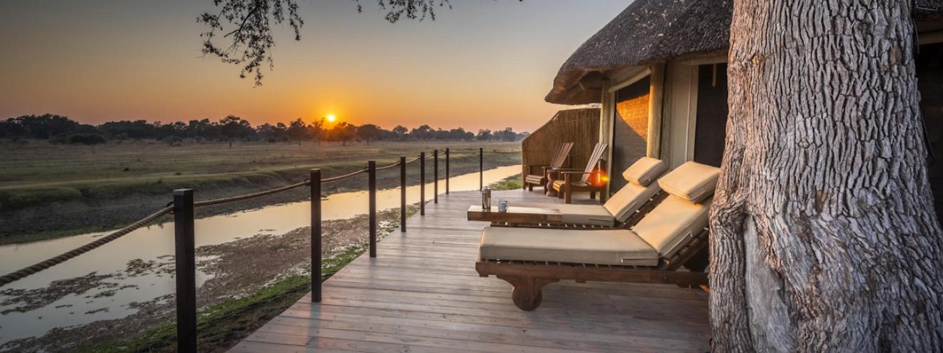 Lion Camp luxury canvas and thatch safari suites elevated on stilted wooden walkways in South Luangwa